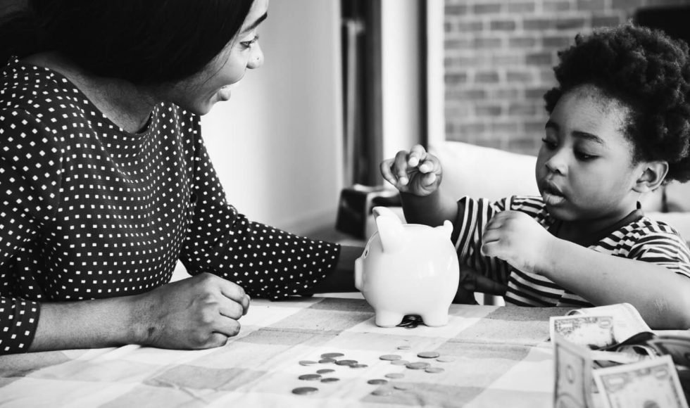 a woman with her child saving for the child's education investment
