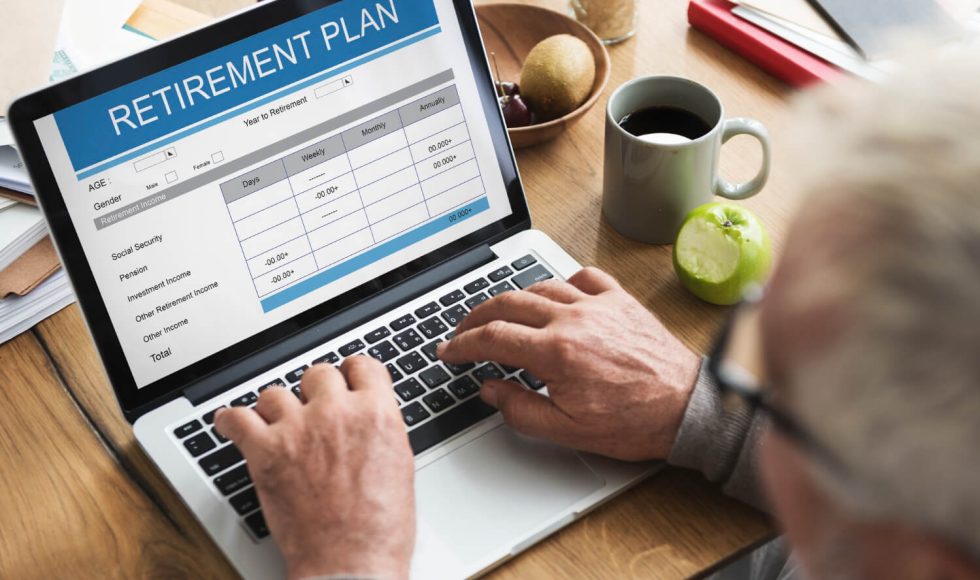 a man planning his early retirement on a computer