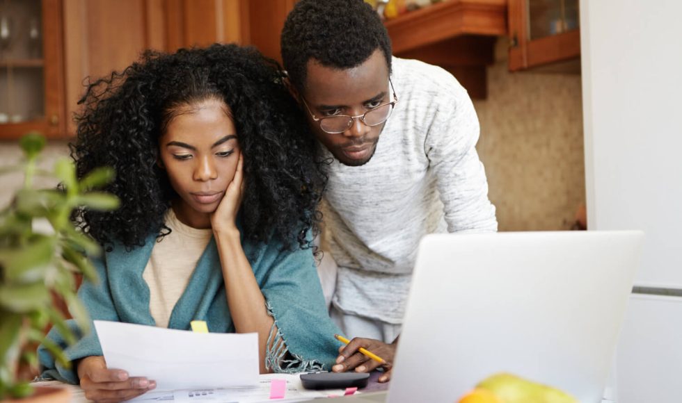 couples looking over their tax account on a computer